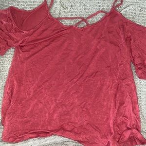 This shirt is a shoulders out top. It’s has straps across the chest.